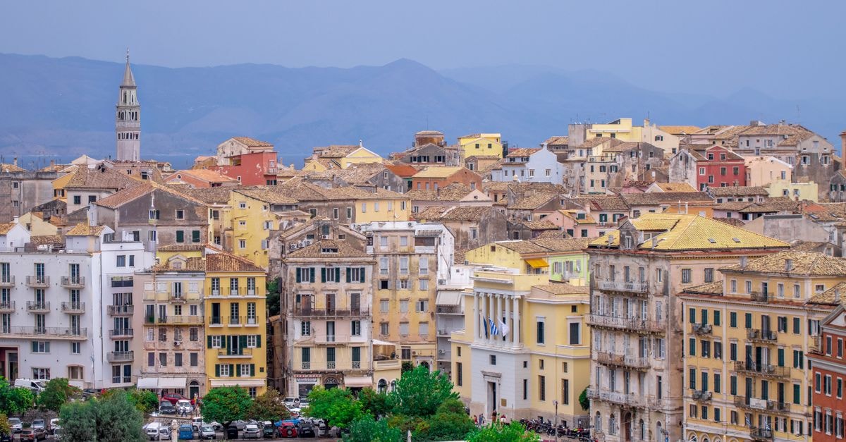 Colorful Venetian-style buildings in Corfu's Old Town, Greece, showcasing historic charm and architectural beauty.