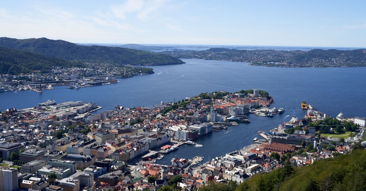 Clarion Hotel Tyholmen in Arendal: A Quay-Side Stay on Galtesund Aerial view of Bergen's cityscape and harbor, showcasing its architecture and waterways.