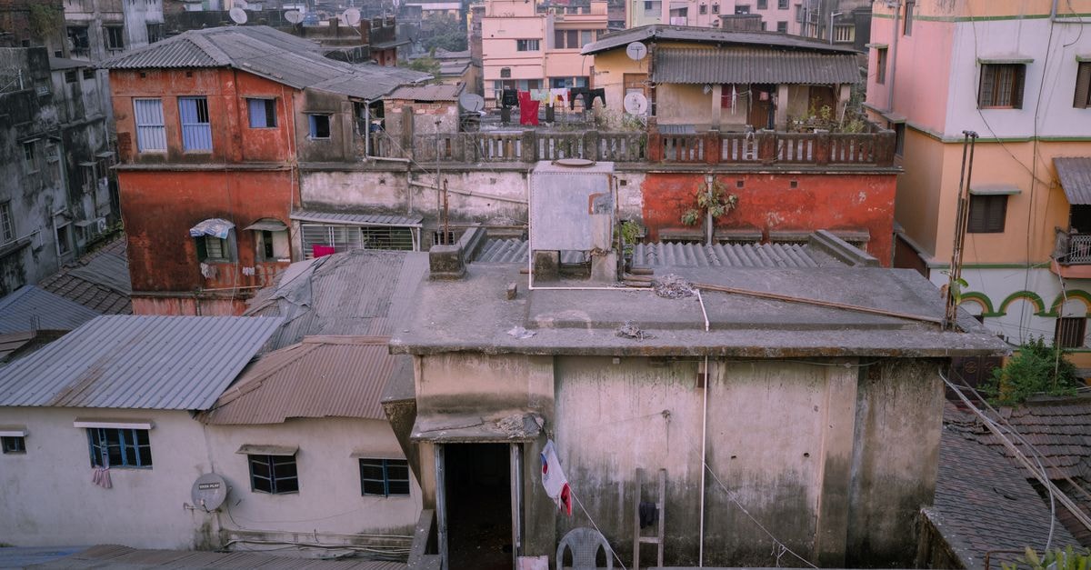 Georgian Inn, Kolkata: Central Stay Near Esplanade Aerial view of urban rooftops in Kolkata, India showcasing vibrant city life.