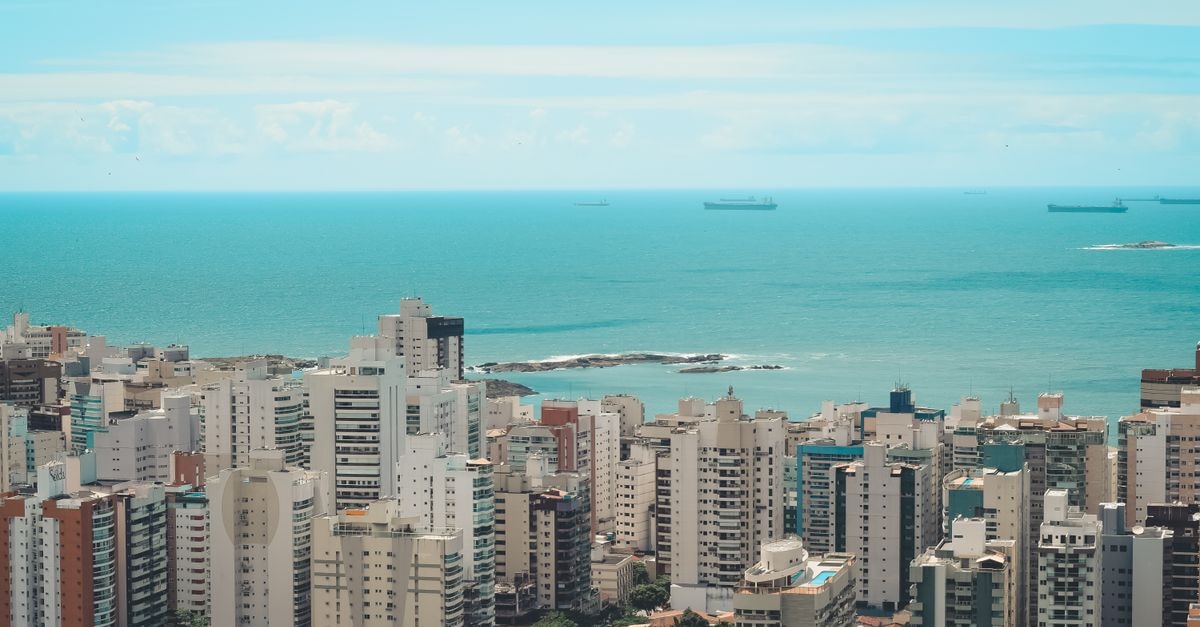 Salvador da Bahia Travel Guide: Pelourinho, the Castro Alves Theater, and the Beating Heart of Afro-Brazilian Culture High angle view of a modern coastal city with skyscrapers and ocean backdrop.