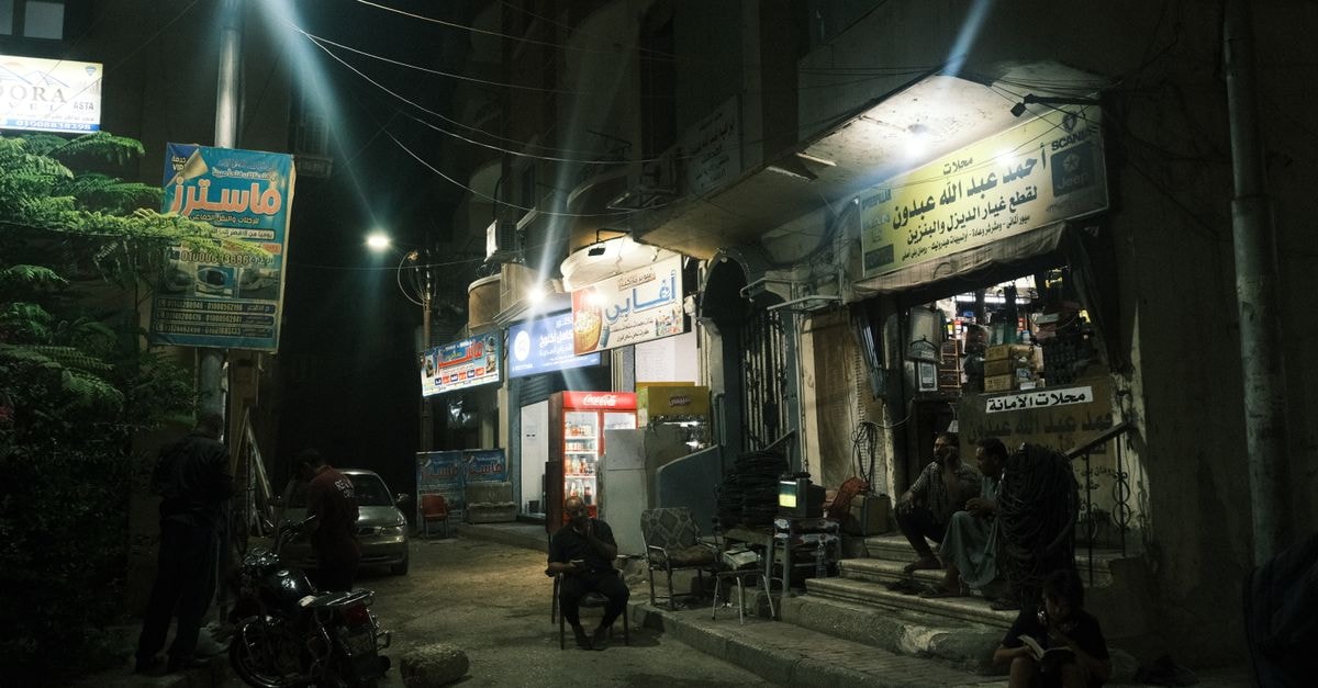 Jalalabad Travel Guide: An Afghan Crossroads Reawakening Urban night view of a local shopfront in Luxor, Egypt, showcasing a vibrant street atmosphere.