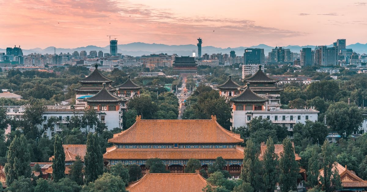 A beautiful cityscape of Beijing featuring historic temples at sunset, capturing the mix of tradition and modernity.
