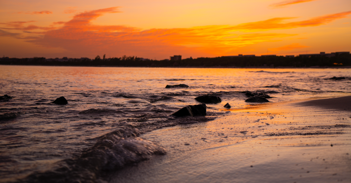 Mahdia Travel Guide: A Quiet Tunisian Peninsula Worth Discovering Captivating sunset over Playa del Carmen with waves gently reaching the shore.