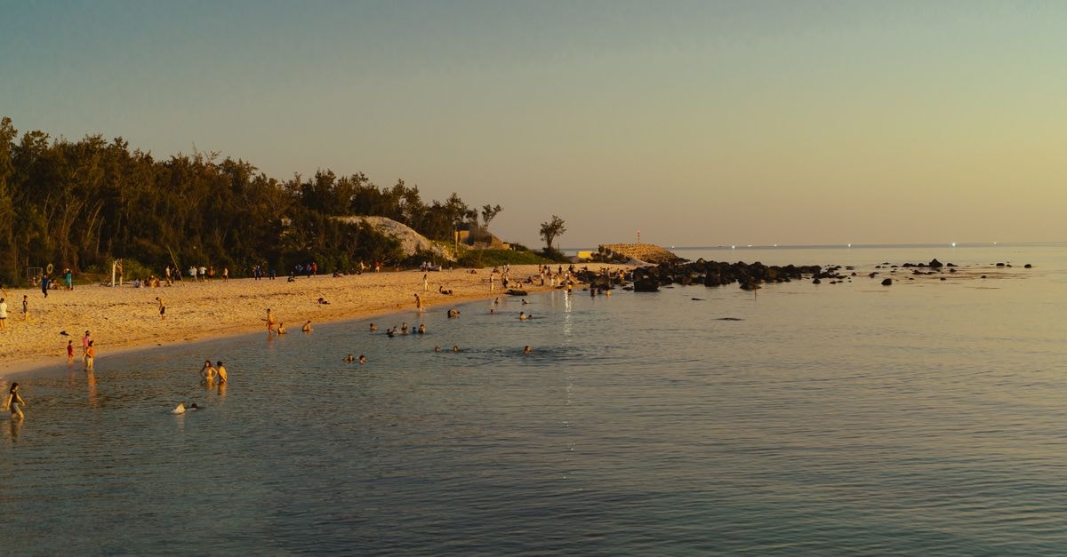 Saipan Travel Guide: White Sand, Warm People, Quiet Island Time Relaxing sunset at Phu Quy Beach, Vietnam highlighting serene waters and sand.