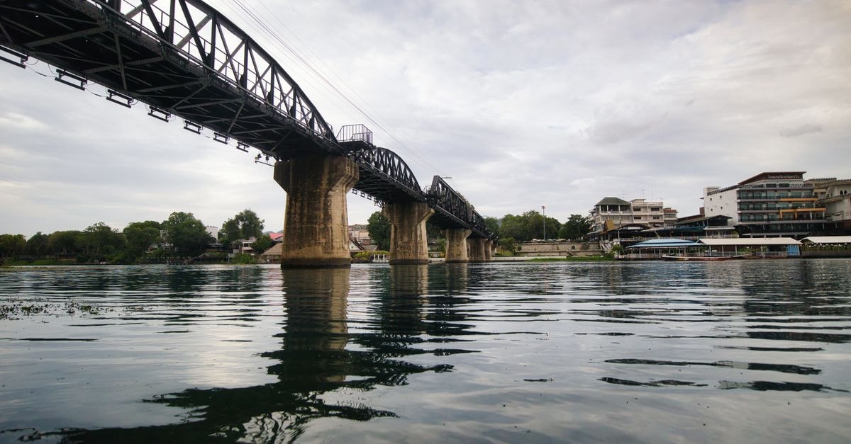 Hop Inn Kanchanaburi in Kanchanaburi: A Wallet-Friendly Base Near the River Kwai Scenic view of the Bridge on the River Kwai spanning water in Kanchanaburi, Thailand.