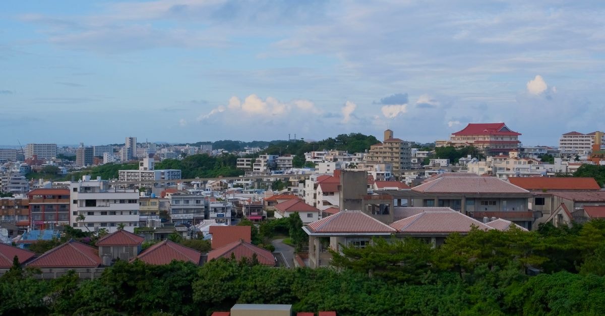 Panoramic view of Okinawa cityscape with traditional and modern buildings.