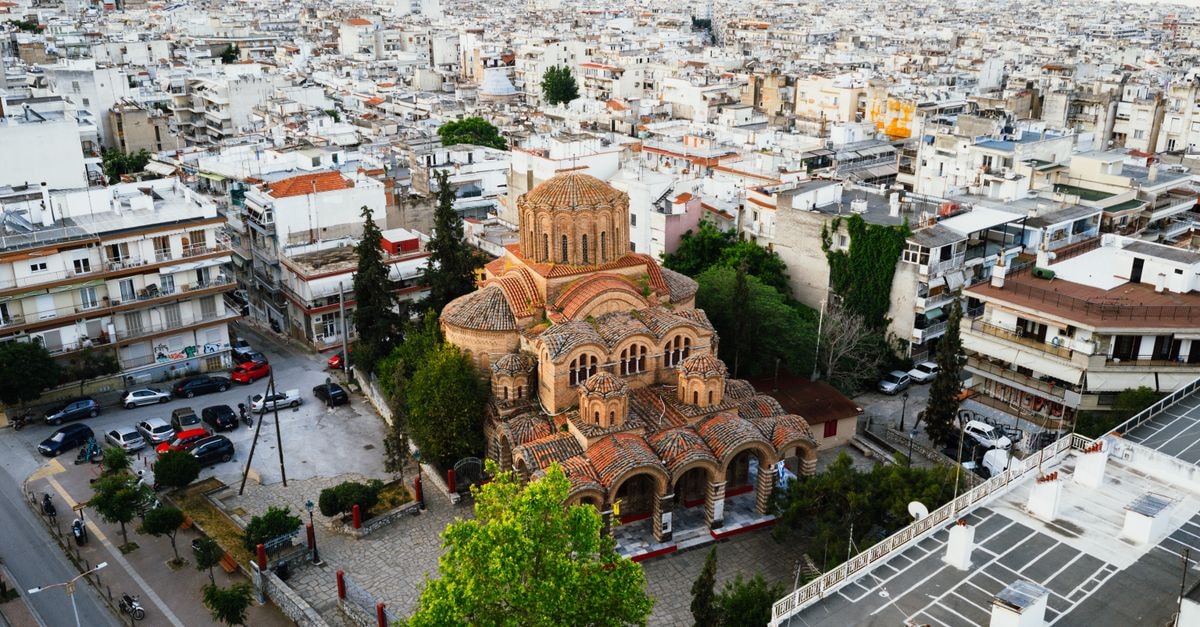 A Quiet Discovery in Central Greece: Lamia Travel Guide Capture of a Byzantine church in Thessaloniki, Greece from above, surrounded by city buildings.