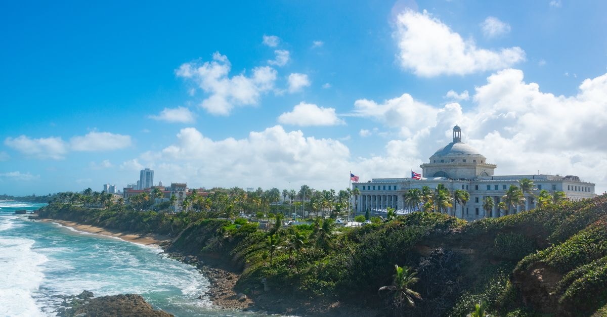 Stunning view of San Juan's coast with the iconic Capitol building against a bright blue sky.