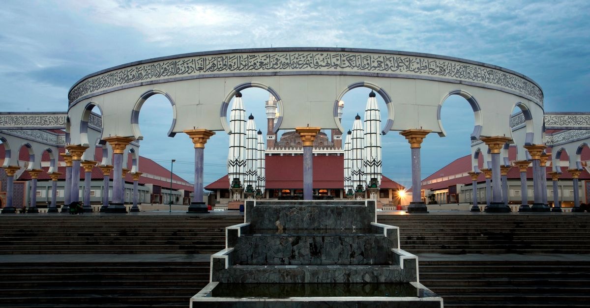 Santika Premiere Semarang in Semarang: Indonesian Hospitality on Jalan Pandanaran Majestic view of the Grand Mosque's archways and central courtyard at twilight.