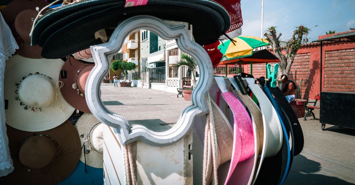 Willemstad travel guide: a slow, colorful way to see Curaçao Colorful assortment of hats on display at a lively street market in Pacasmayo, Peru, capturing local charm.