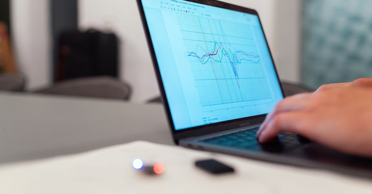 Meta unveils audio-only AI glasses, tightens recording-light rules to address privacy concerns A person working on a graph analysis on a laptop for data monitoring and research.
