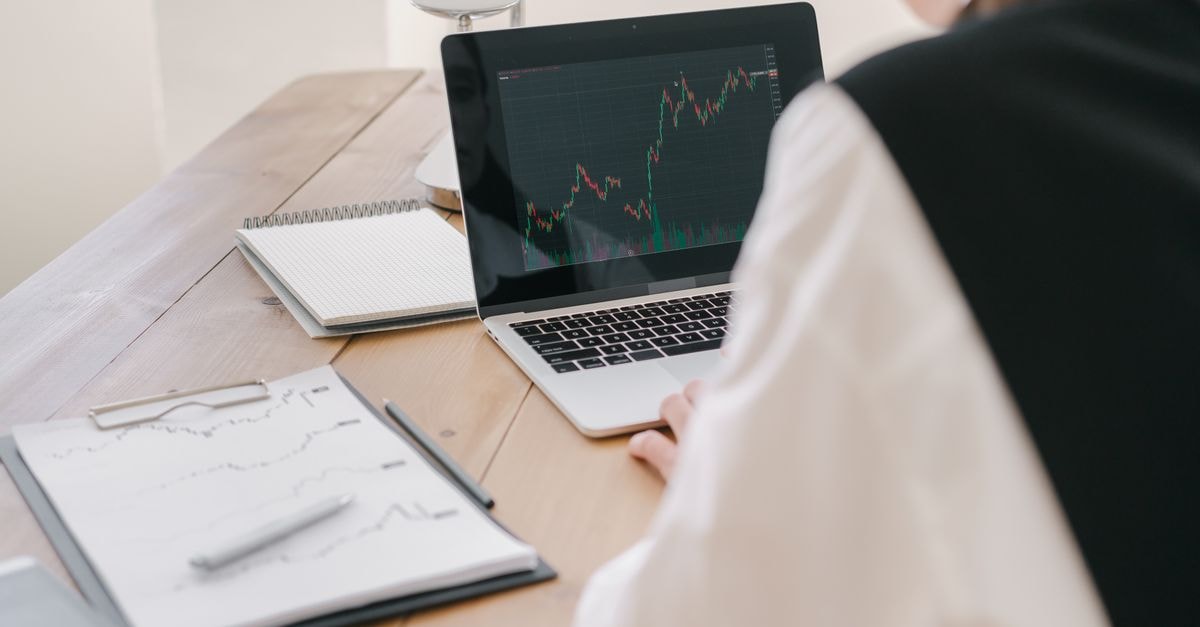 Axis Direct puts ICICI Bank among top bank picks after Q1, sets Rs 1,800 target Business professional analyzing stock market trends on a laptop inside an office setting.