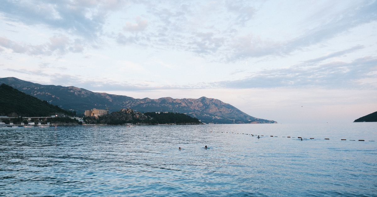 Tranquil Adriatic Sea view with distant mountains and serene water in Budva, Montenegro.