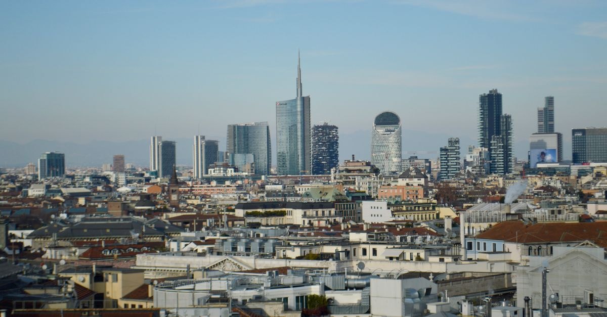 Matilde Boutique Hotel in Milan: Elegant Rooms Steps from the Duomo Aerial view of Milan skyline showcasing modern skyscrapers and urban landscape under a clear blue sky.
