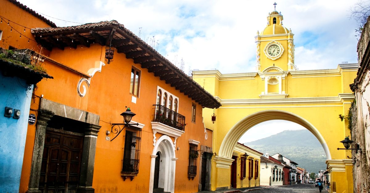 Hotel Santa Catalina in Posadas — A Practical Stay Steps from the Bus Terminal Colorful street with Santa Catalina Arch in Antigua, Guatemala. Vibrant colonial architecture and scenic mountainous backdrop.