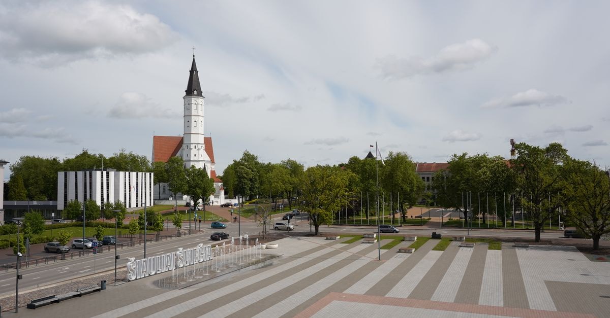 Šiaulių Viešbutis in Šiauliai: A Civic-Stay Address in Northern Lithuania A view of Šiauliai, Lithuania featuring a prominent church and city square.