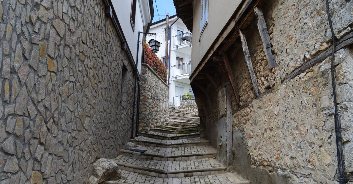 Zelino, North Macedonia: An Off-the-Beaten-Path Village Travel Guide Quaint stone alley with stairs in Ohrid, showcasing rustic architecture and inviting ambiance.