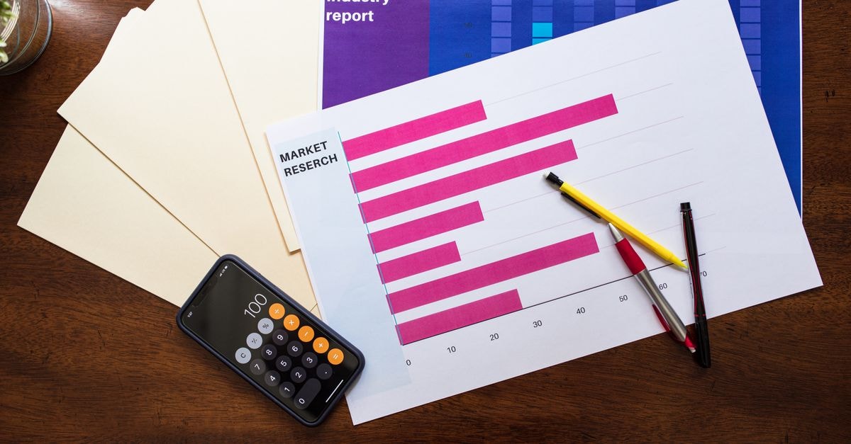 Apple India revenue growth signals stronger regional scale Top view of market research reports and calculator on a wooden desk, illustrating business analysis.