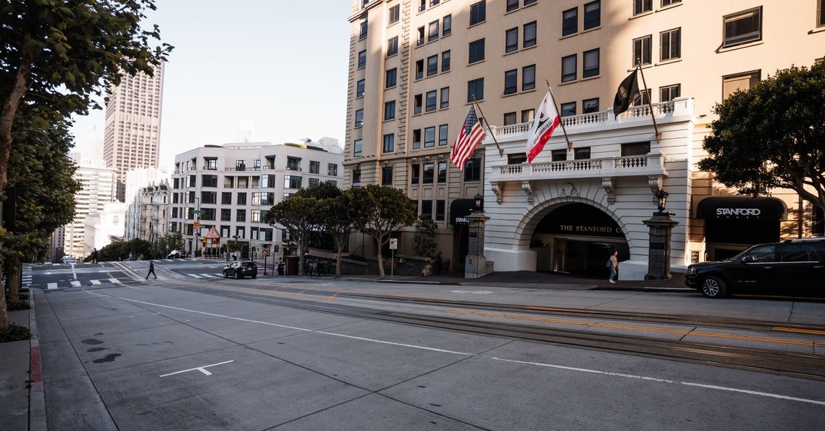 Streetscape of San Francisco featuring the Stanford Court Hotel and city architecture.