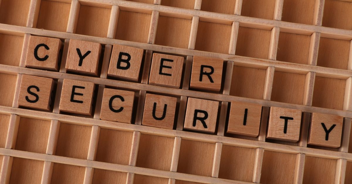 Coca-Cola Resumes Fairlife Production After Ransomware Attack and Confirms Data Breach Wooden letter blocks spelling 'CYBER SECURITY' on a wooden grid background for data protection themes.