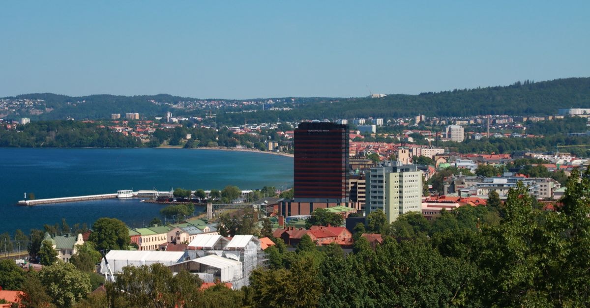 A scenic aerial view of Jönköping, Sweden with Vättern Lake and lush greenery during a bright summer day.