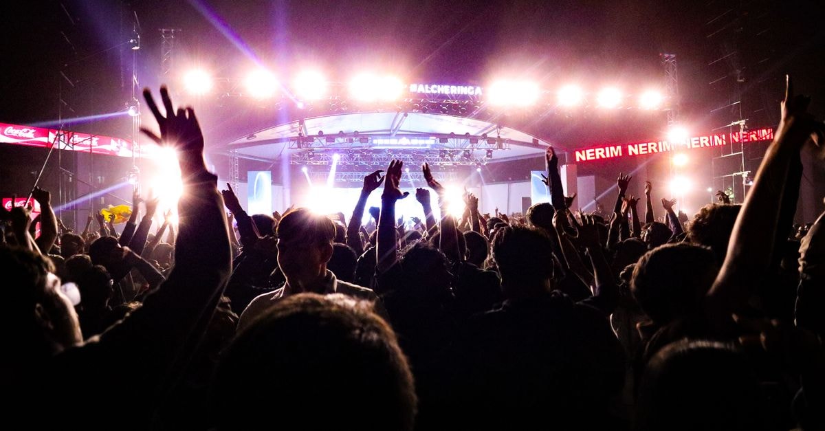 Diljit Dosanjh announces seven-city India leg of Aura Tour from November Energetic crowd enjoying a live concert under bright stage lights in Guwahati, India.