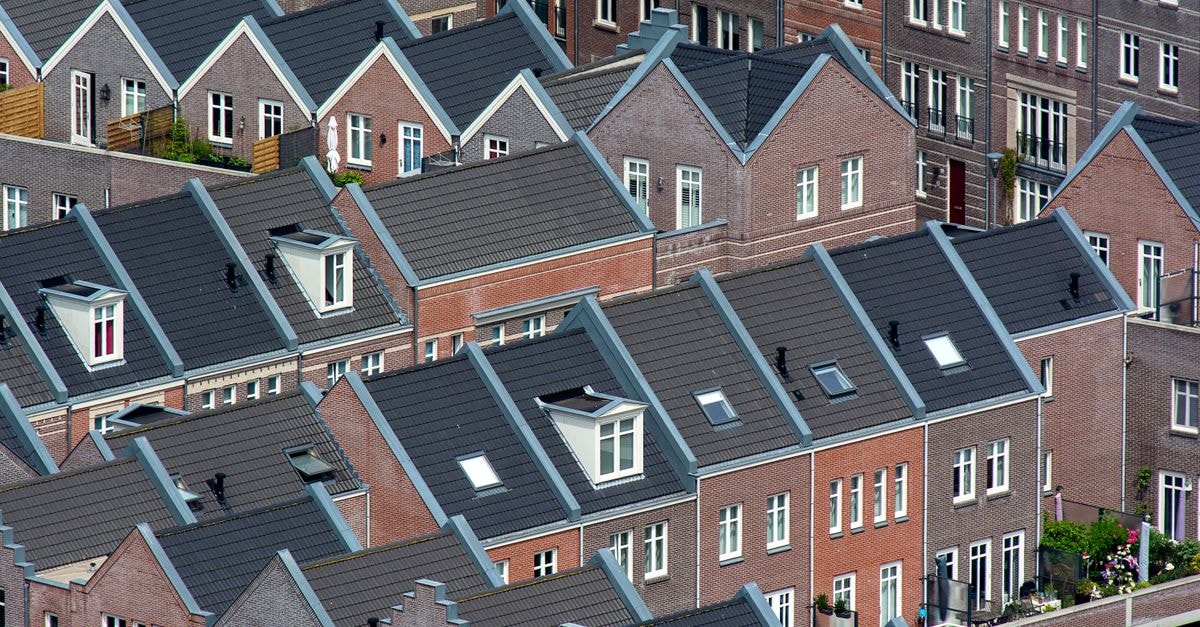Aerial view of traditional Dutch townhouses in Den Haag, showcasing unique architecture.