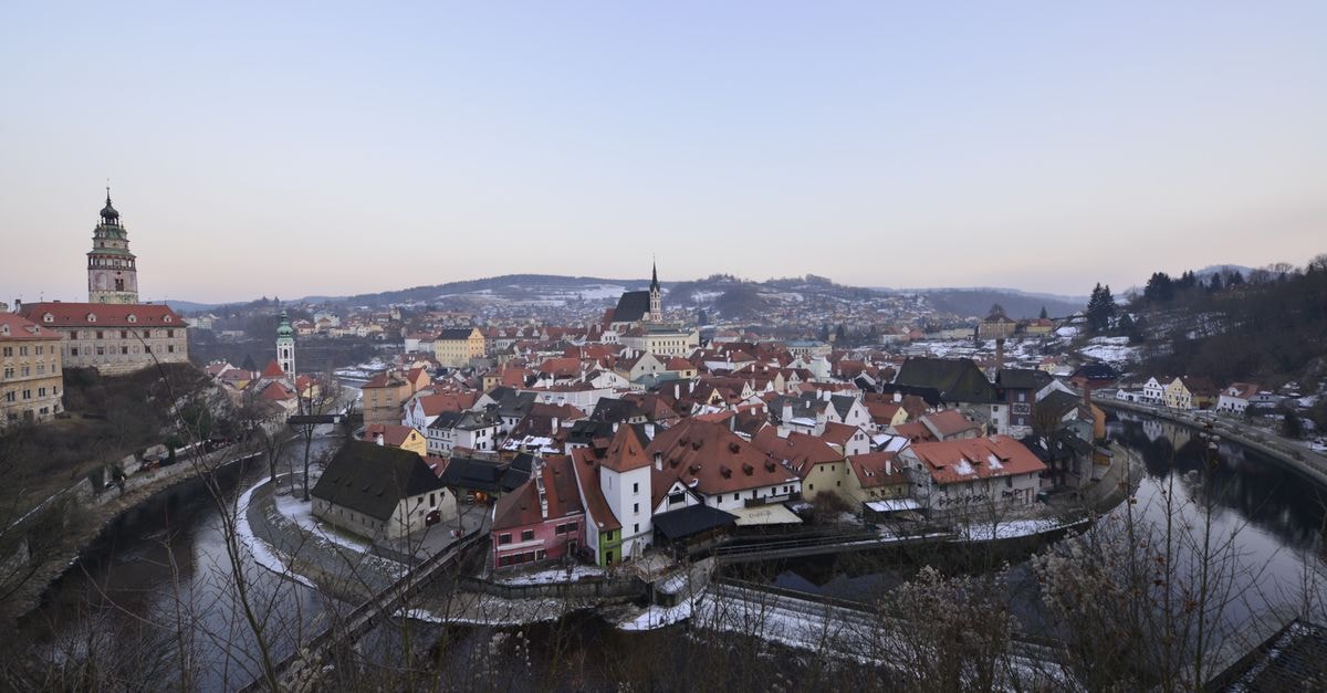 Cesky Krumlov Travel Guide: A Slow Walk Through a Bohemian Storybook Aerial view of Cesky Krumlov, Czech Republic, with historic buildings and Vltava River in winter.