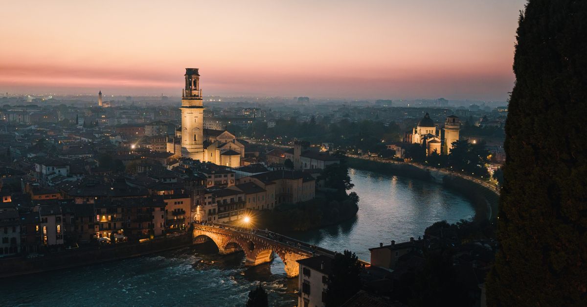 A breathtaking sunset over Verona, Italy, capturing its historic architecture and the shimmering Adige River.