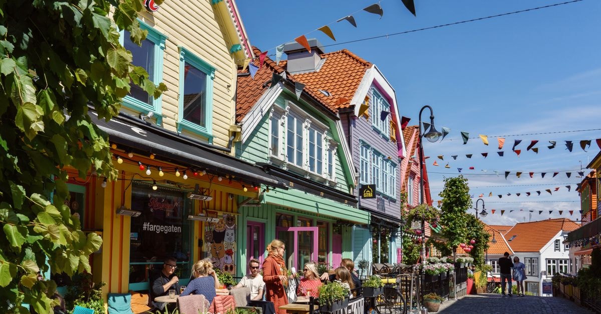 Vibrant street view of colorful houses and cafes in Stavanger, Norway.