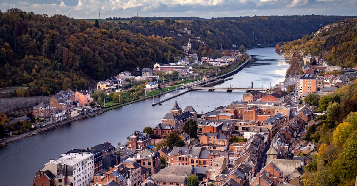 Pentahotel Liège, Belgium — A Modern Stay at the Edge of Le Carré Breathtaking aerial view of Dinant with the Meuse River winding through Wallonia, Belgium.
