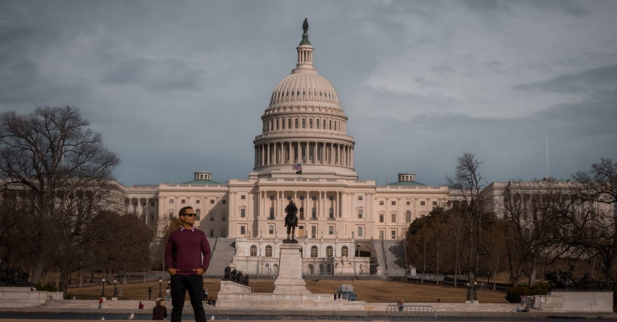 Washington D.C. travel guide: a slow, walkable city worth lingering in Person standing in front of the iconic United States Capitol on a clear day.