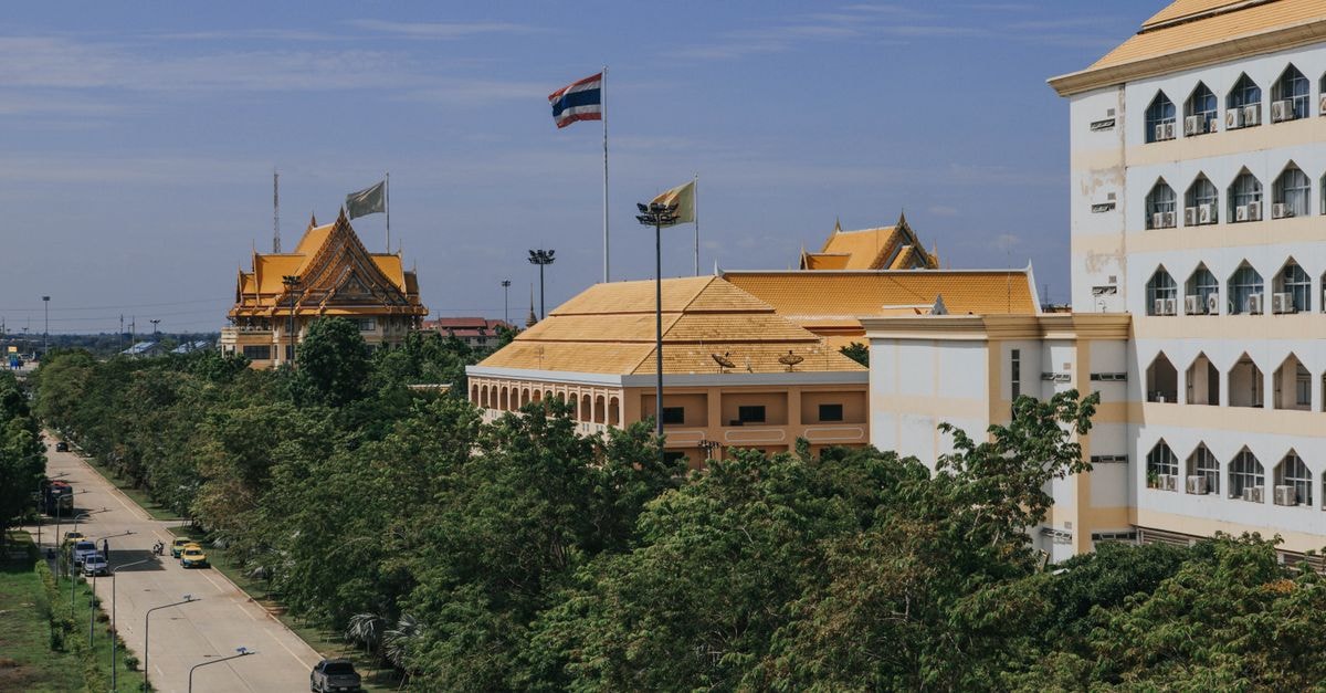 Udoncabana in Udon Thani: Steps from Nong Prajak Park A scenic view of Ayutthaya university campus with golden roofs in Thailand, showcasing traditional architecture.