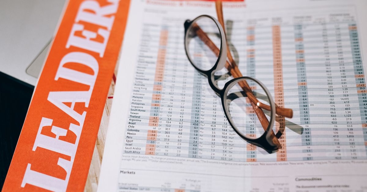 Blackstone joins race to acquire Fairfax's IIFL Finance stake Close-up of financial documents with eyeglasses, depicting data analysis and business insights.