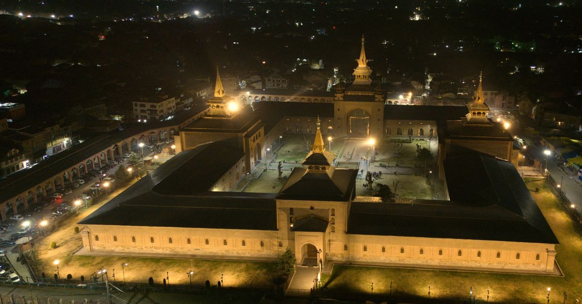 Classic Grande in Imphal: Rooftop Grills, Live Music & Manipur Hospitality A stunning aerial night view of Jamia Masjid in Srinagar, capturing its architectural beauty and illuminated surroundings.