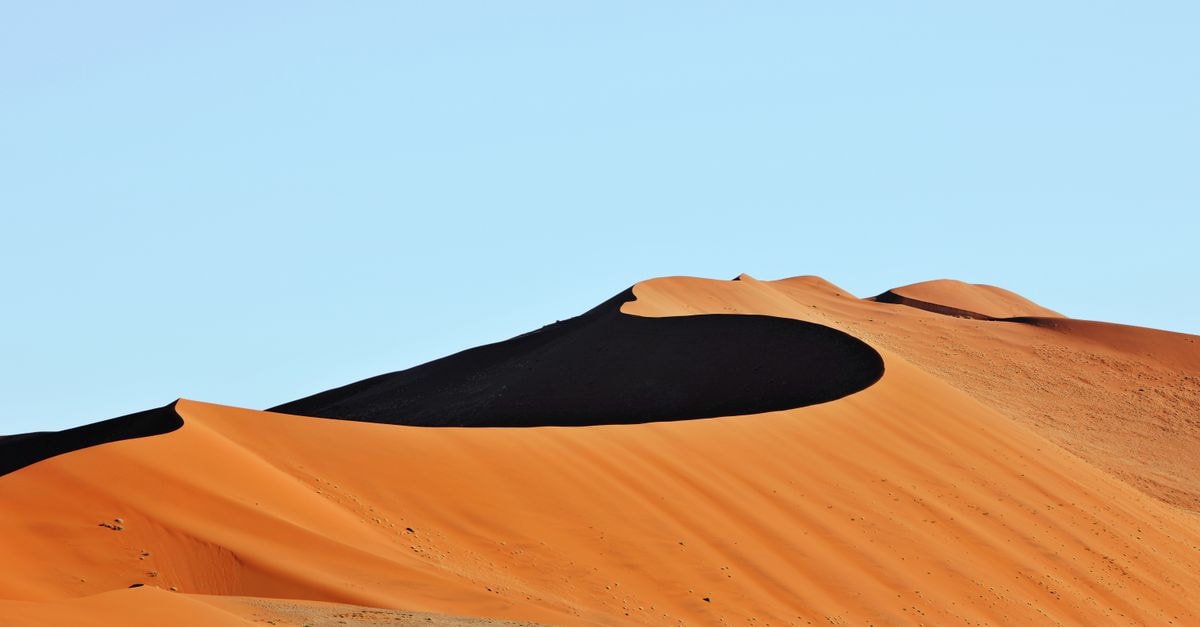 Keetmanshoop Travel Guide: Slow Days in Namibia's Karas Capital Stunning view of the vibrant orange sand dunes in Sossusvlei, showcasing natural beauty.