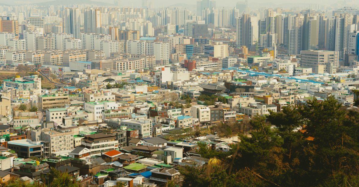 Chuncheon Tourist Hotel in Chuncheon: A Central Jungangno Address A panoramic view of Seoul's dense urban architecture under a hazy sky.