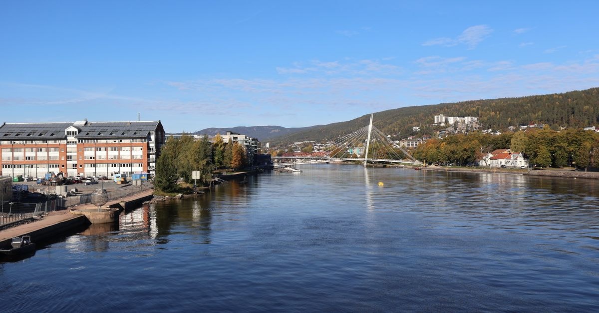 A Riverside Pause in Drammen: A Slow Travel Guide Beautiful riverside scene with modern bridge under clear blue skies in Norway.