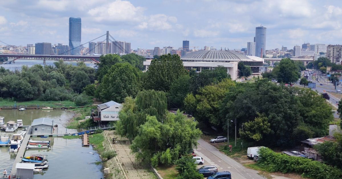 Hotel Ramada Slatina Parc in Slatina: An International-Brand Stay on Crișan Street A scenic birds-eye view of Belgrade cityscape, featuring the river and urban landscape under a blue sky.
