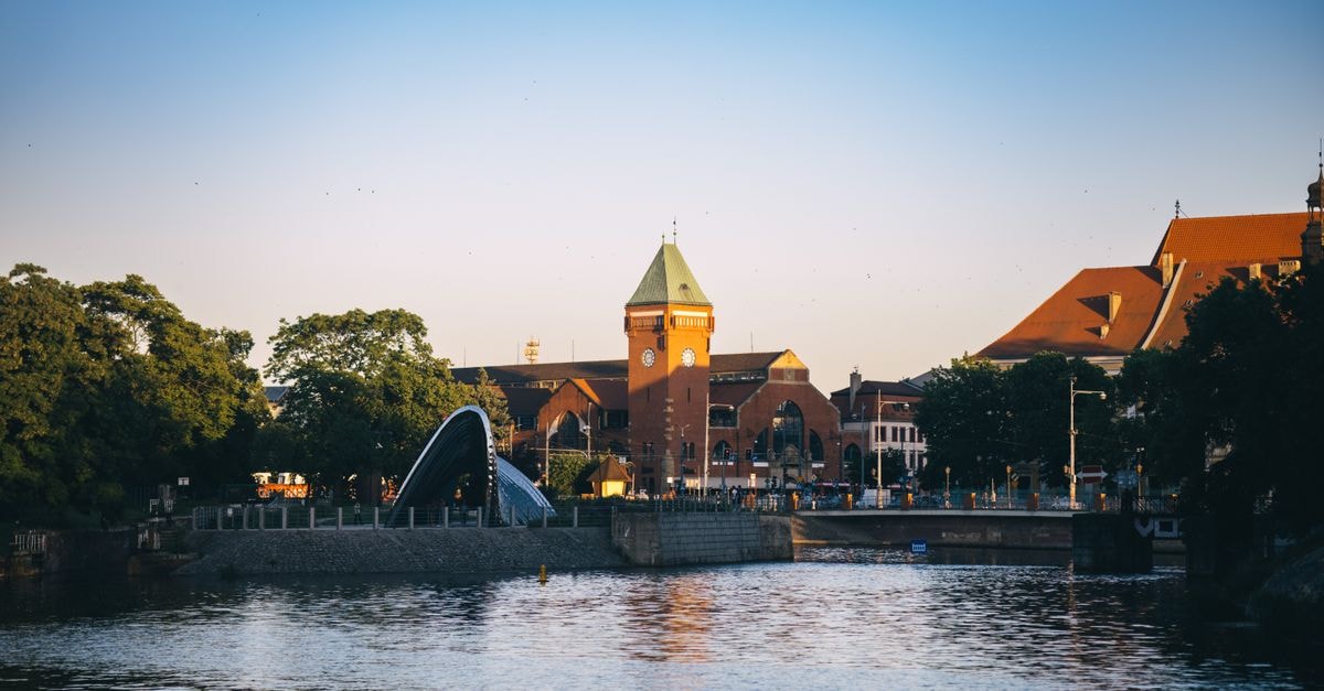 Katowice Travel Guide: Silesian City of Green Contrasts Scenic riverfront view with historic architecture in Wroclaw, Poland, during sunset.