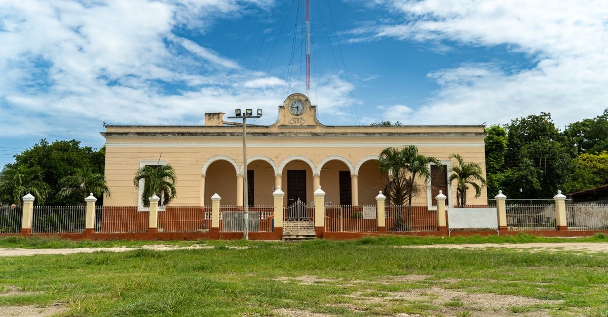 Historic colonial building in Suma, Yucatán under a vibrant blue sky.