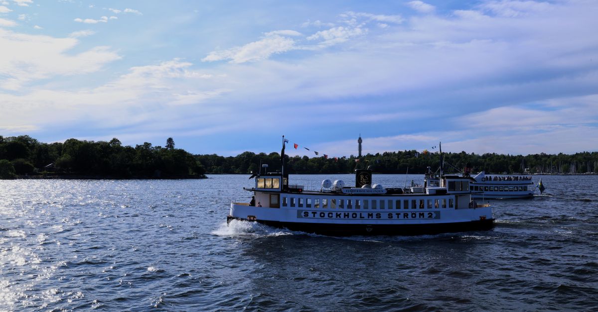 Enjoy a picturesque view of boats cruising on Stockholms Ström under blue skies.