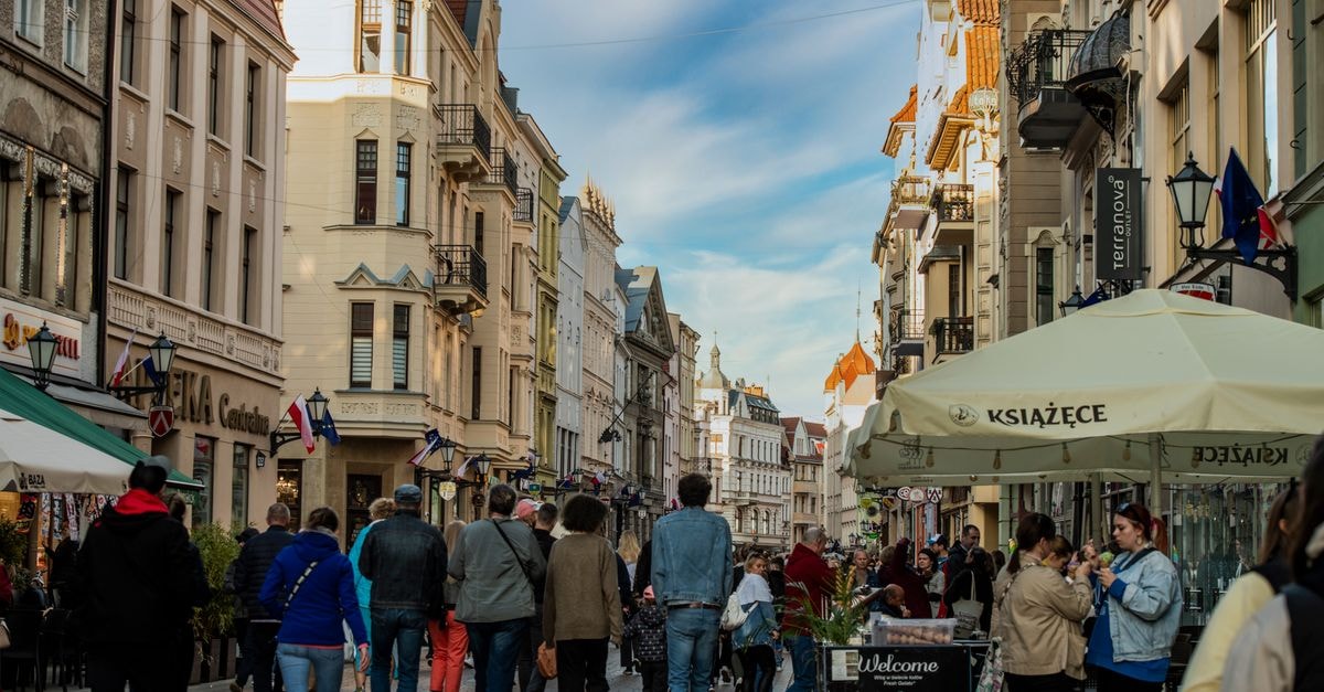 Kielce Travel Guide: Planning Tips, Costs and Things to Do Lively urban scene on a European street with historic buildings and bustling crowd.