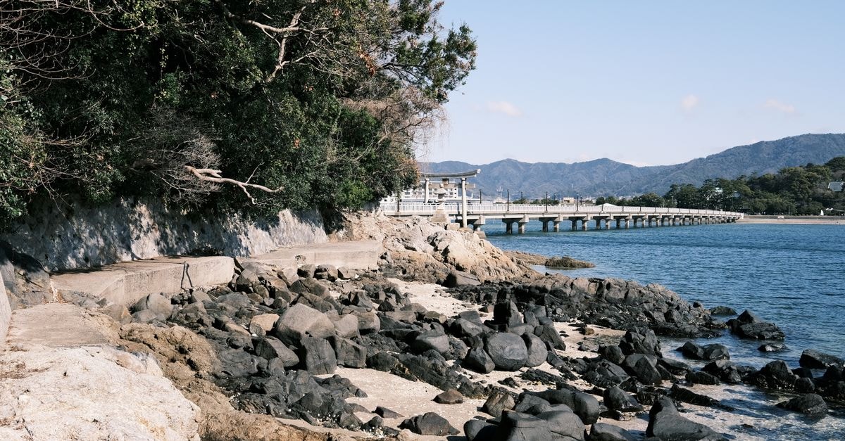 Toyohashi Travel Guide: Quiet Corners of Aichi Explore the picturesque rocky beach and serene pier in Gamagōri, Aichi, Japan.