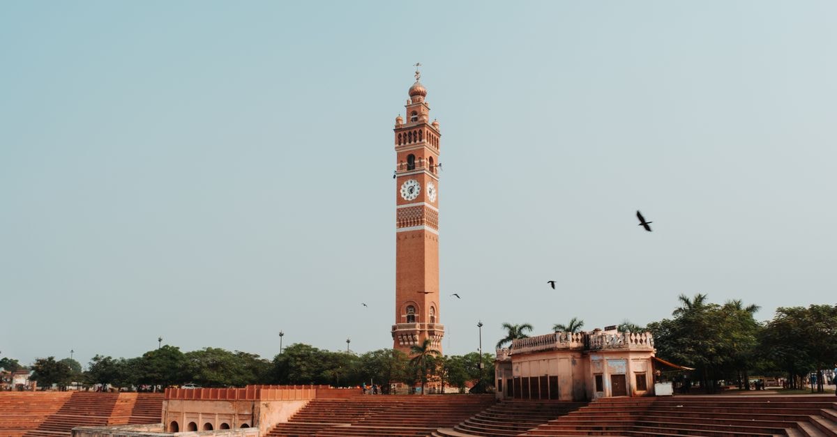 Lucknow Homestay in Lucknow: A Seventeen-Year Host Family Story Majestic view of Husainabad Clock Tower in Lucknow, India, with clear skies and serene surroundings.