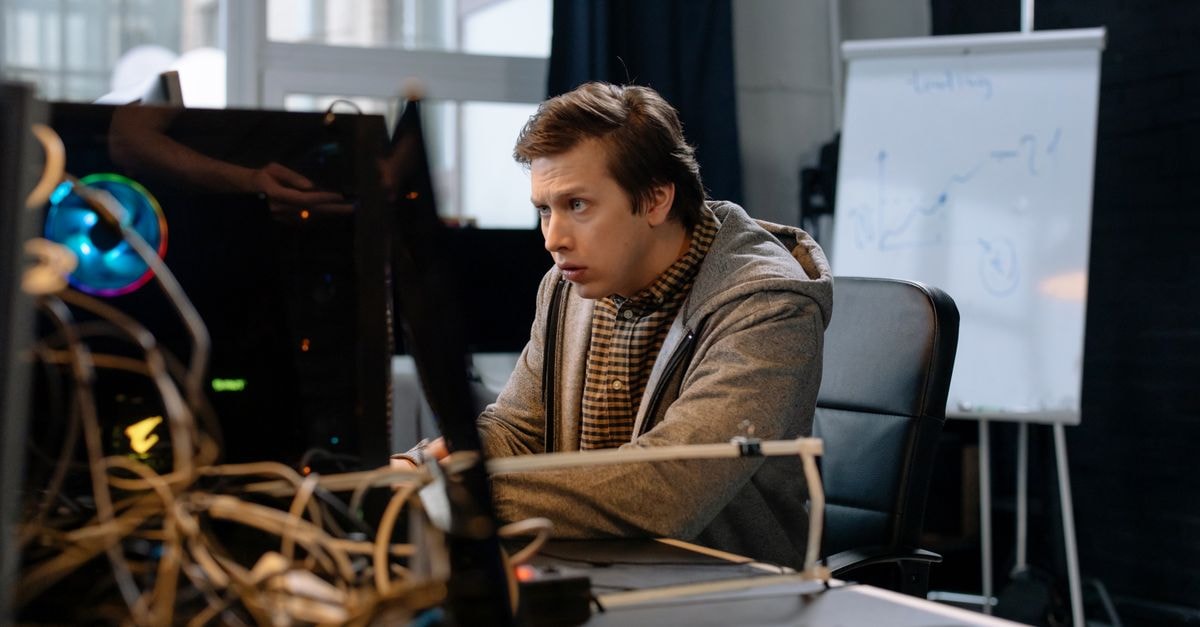 SpaceX's Starship reaches orbit on Flight 14 and deploys 26 Starlink V3 satellites Young man intensely focused on computer work in a tech office setting with a whiteboard in the background.