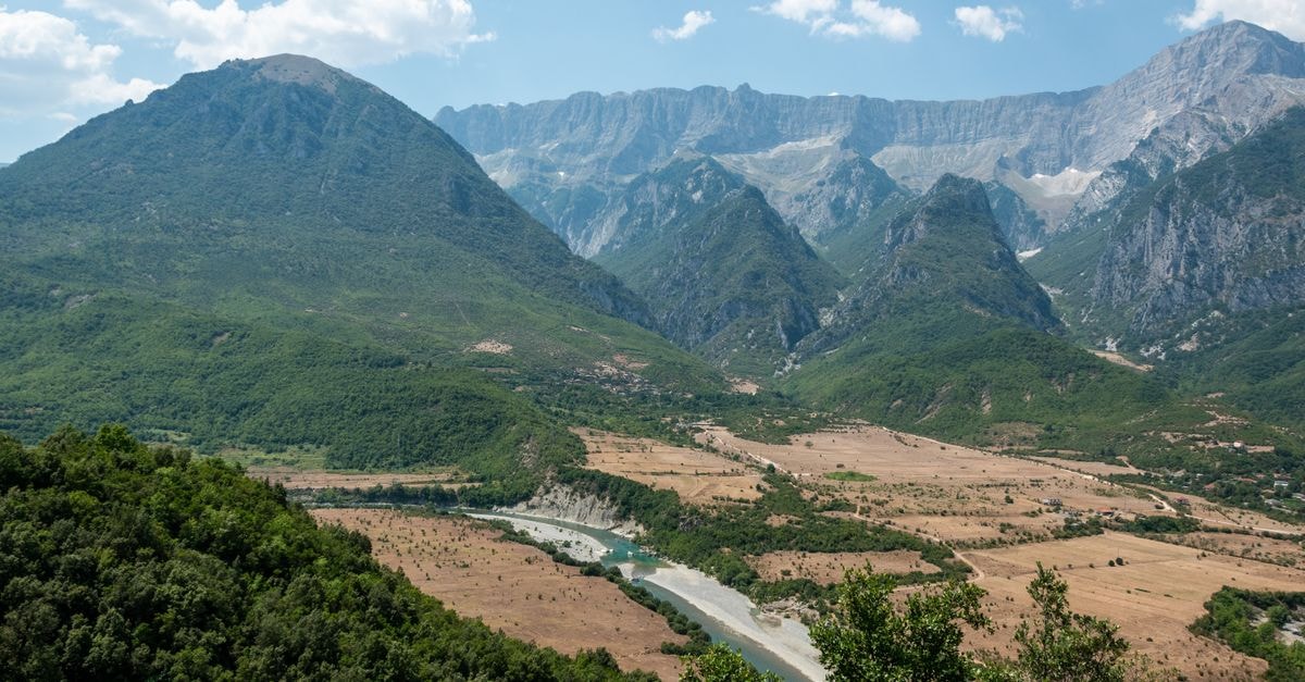 Gostivar Travel Guide: Gateway to the Polog Valley Aerial view of Përmet valley with lush greenery and majestic mountains in Albania.