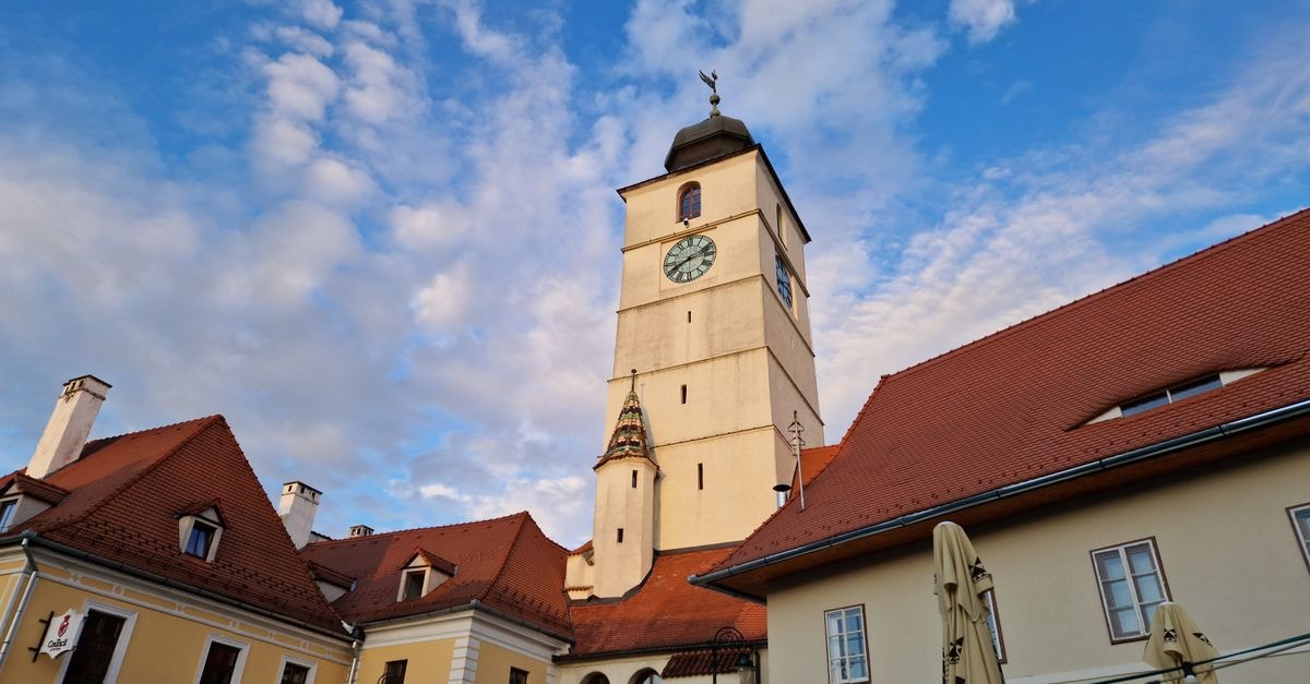 Târgu Mureş Travel Guide: Planning Tips, Costs and Things to Do Captivating view of Turnul Sfatului in Sibiu, showcasing the historic architecture against a vibrant sky.