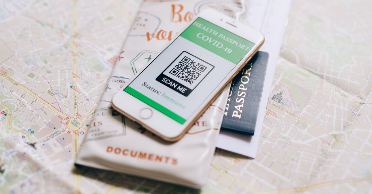 Port Vila Travel Guide: Getting Around, Eating Well, and Planning Smart A smartphone displaying a COVID-19 health passport on a map with a travel passport.