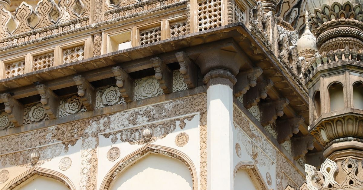 Close-up of ornate architectural details on a historic building facade in Hyderabad, India.